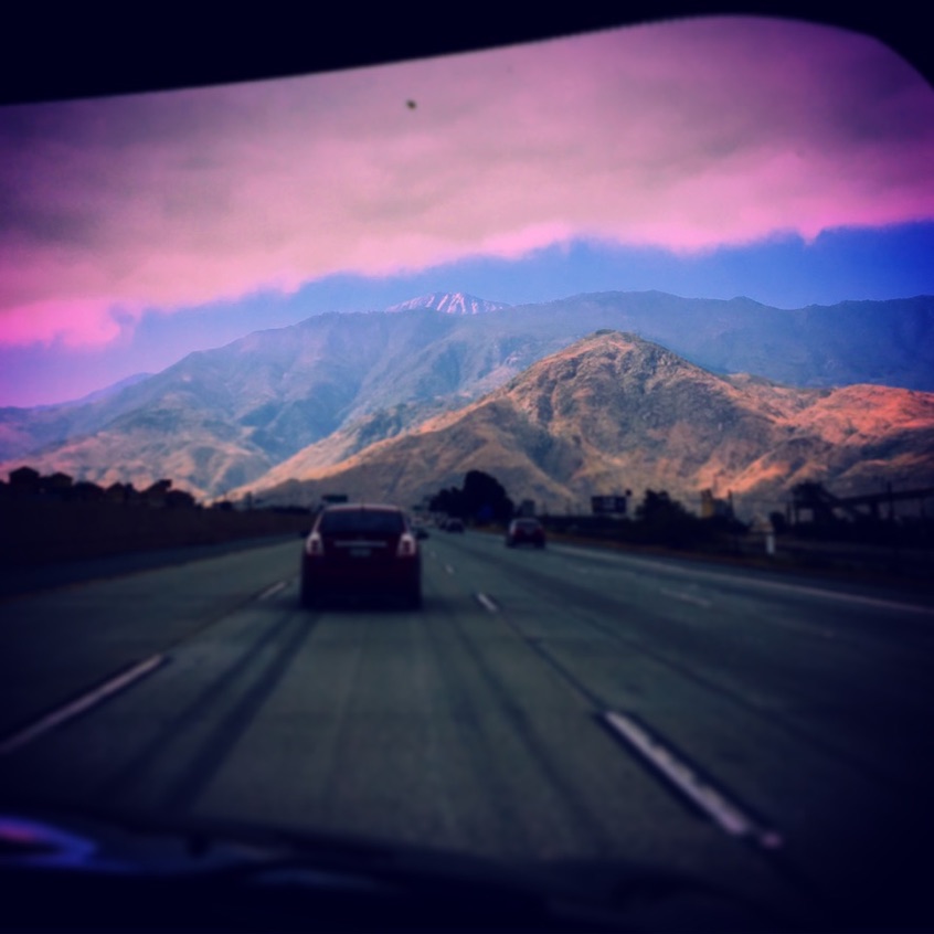 Cars traveling on a mountain highway at dusk
